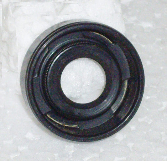 A black rubber seal sitting on top of a white surface.