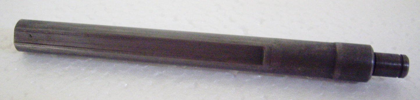 A black pencil is sitting on top of the table.