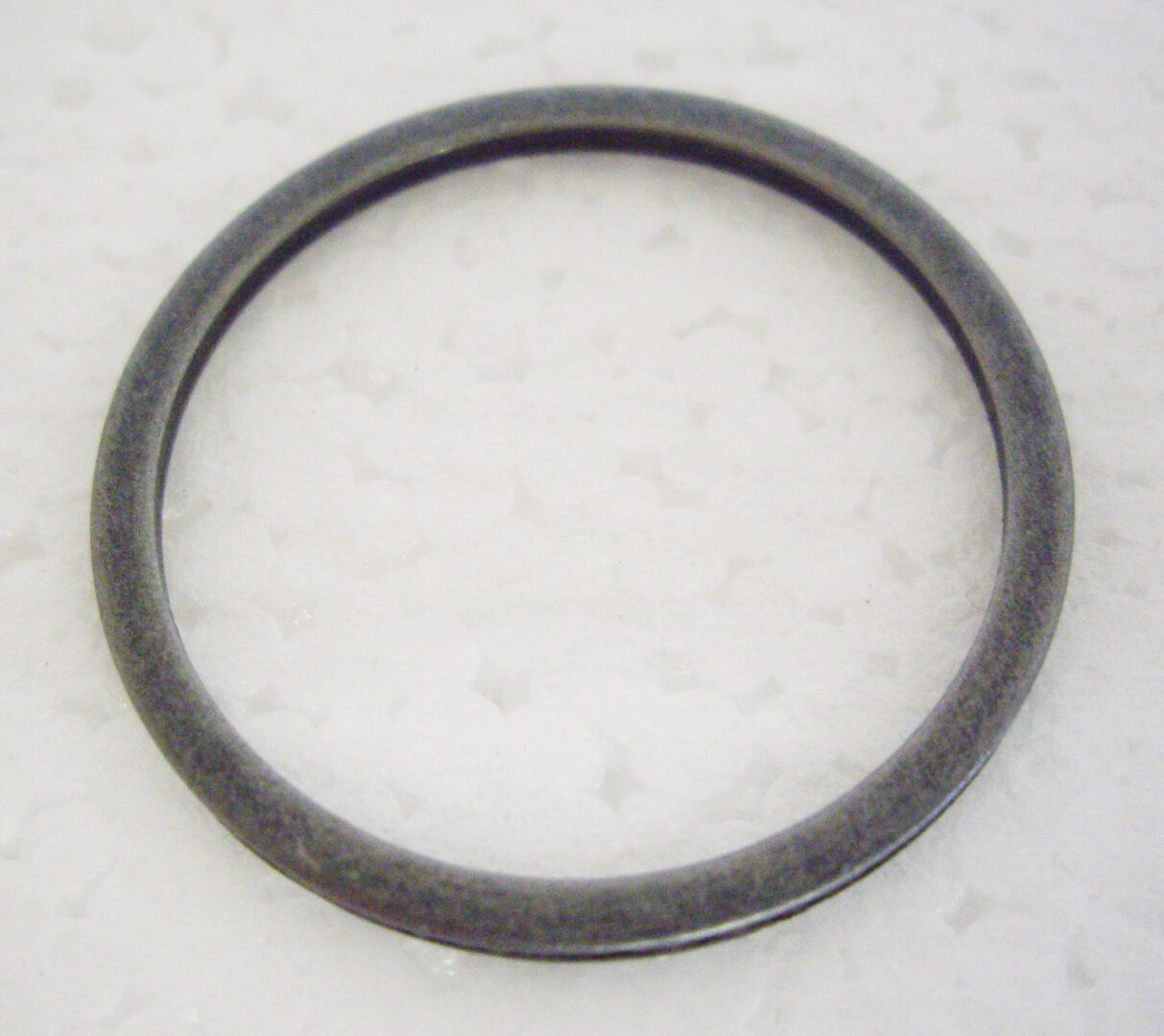 A black ring is sitting on the floor
