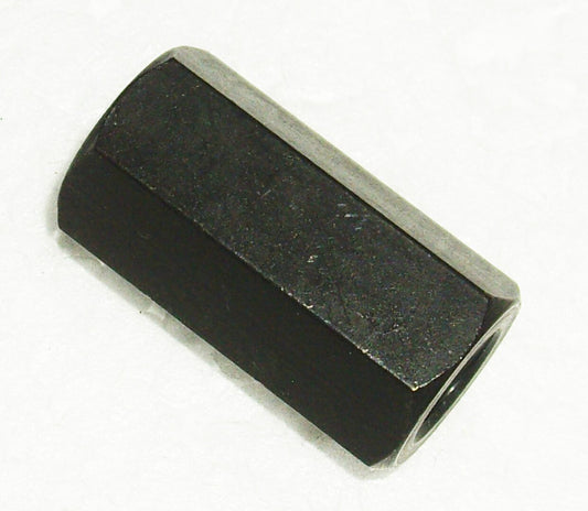 A black nut that is sitting on the ground.