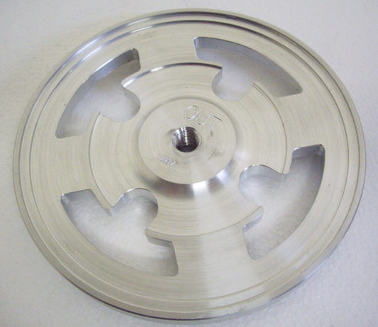 A silver disc with five pieces of metal on it.