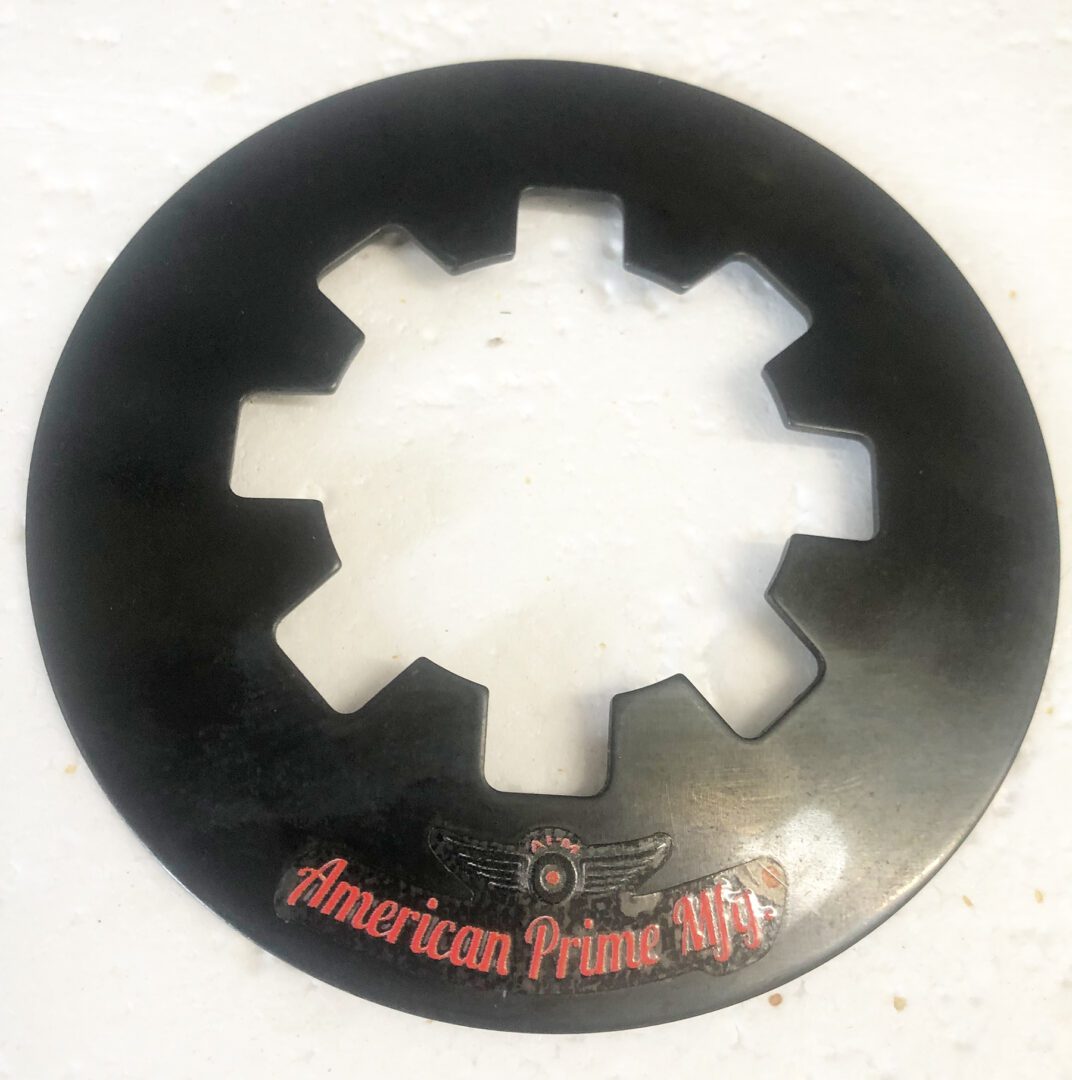 A black circular metal object with the words " american prime life ".
