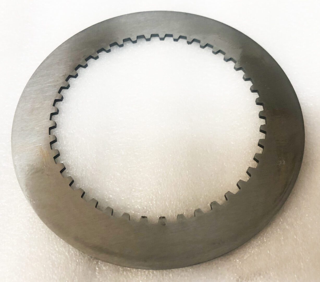 A close up of a metal disc on top of a table