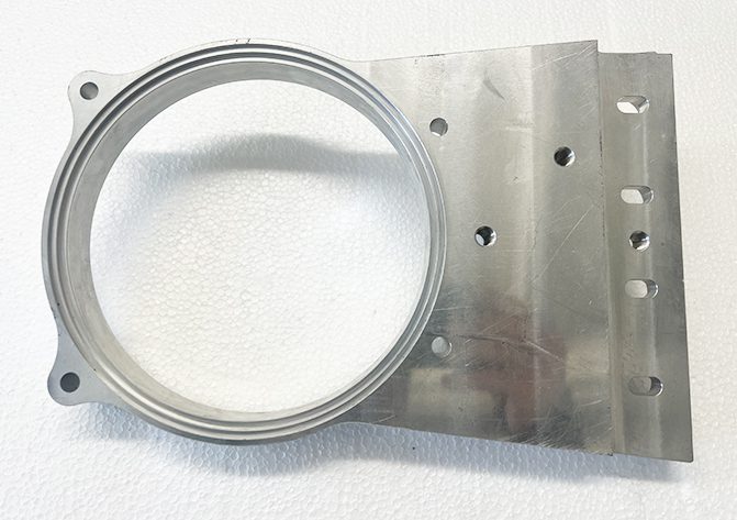 A metal ring sitting on top of a white surface.