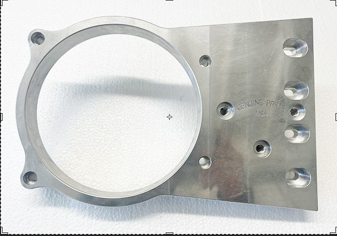 A metal part with holes for the mounting of a device.