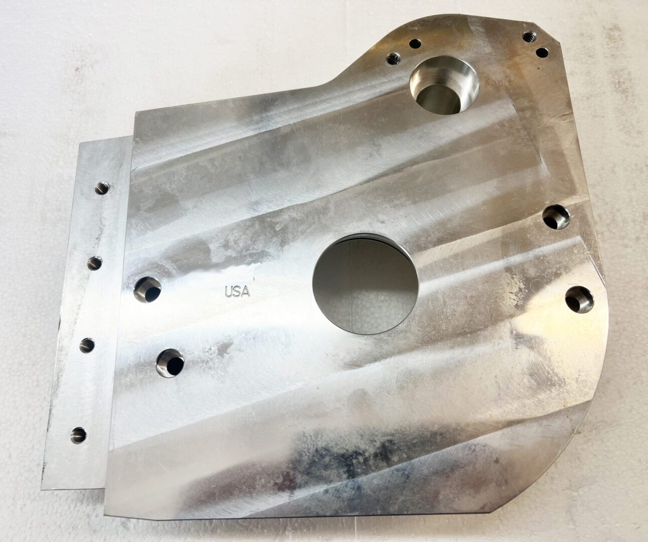 A metal part that is sitting on the floor.