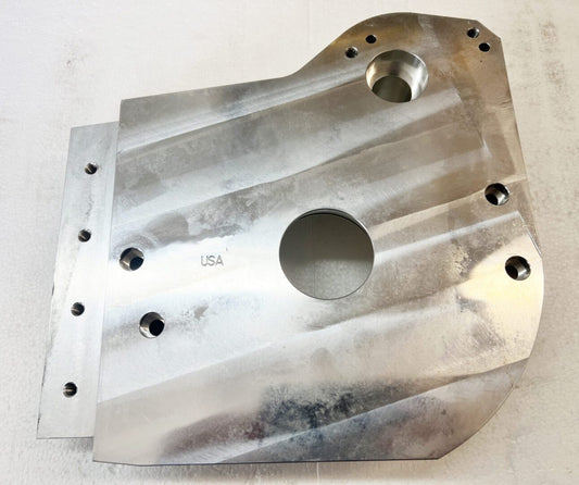 A metal part that is sitting on the floor.