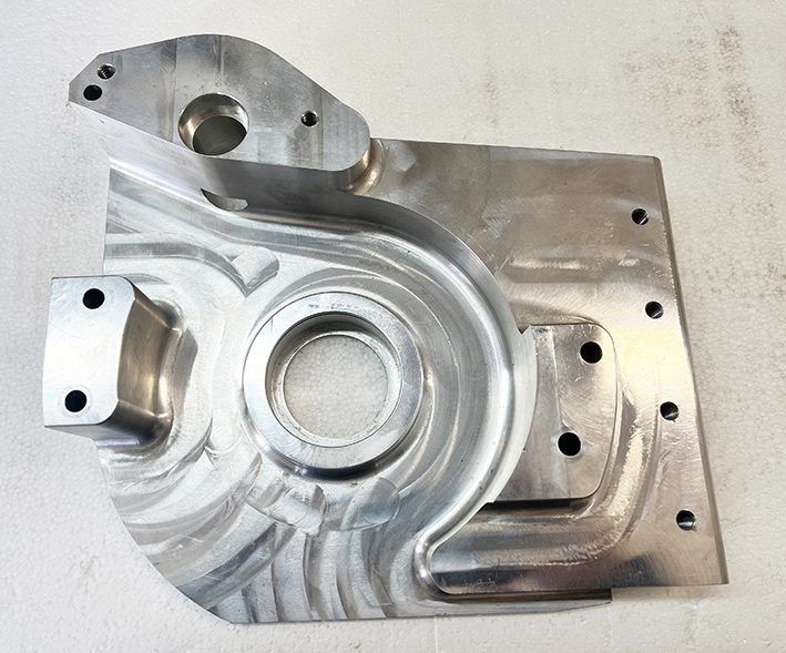 A metal part that is sitting on the ground.