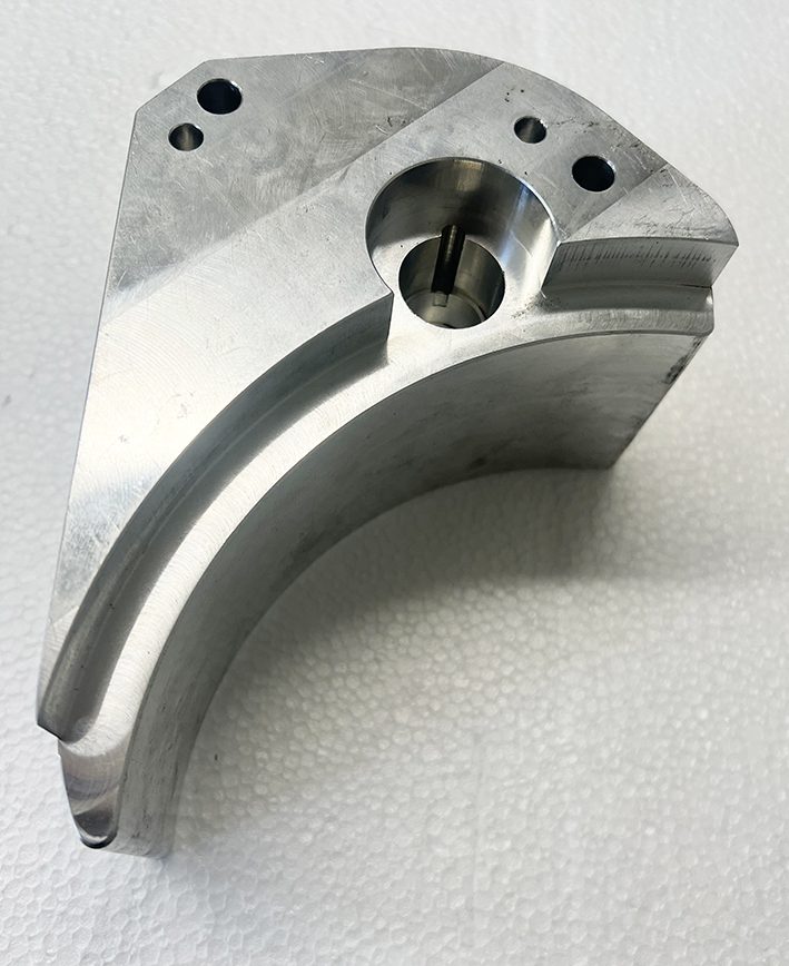 A metal part that is sitting on the ground.