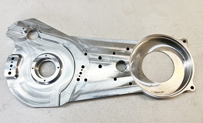 A metal part that is missing some of the holes.