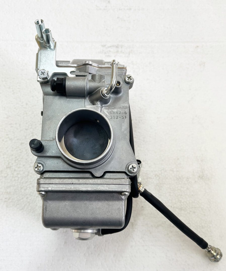 A carburetor is sitting on the wall.