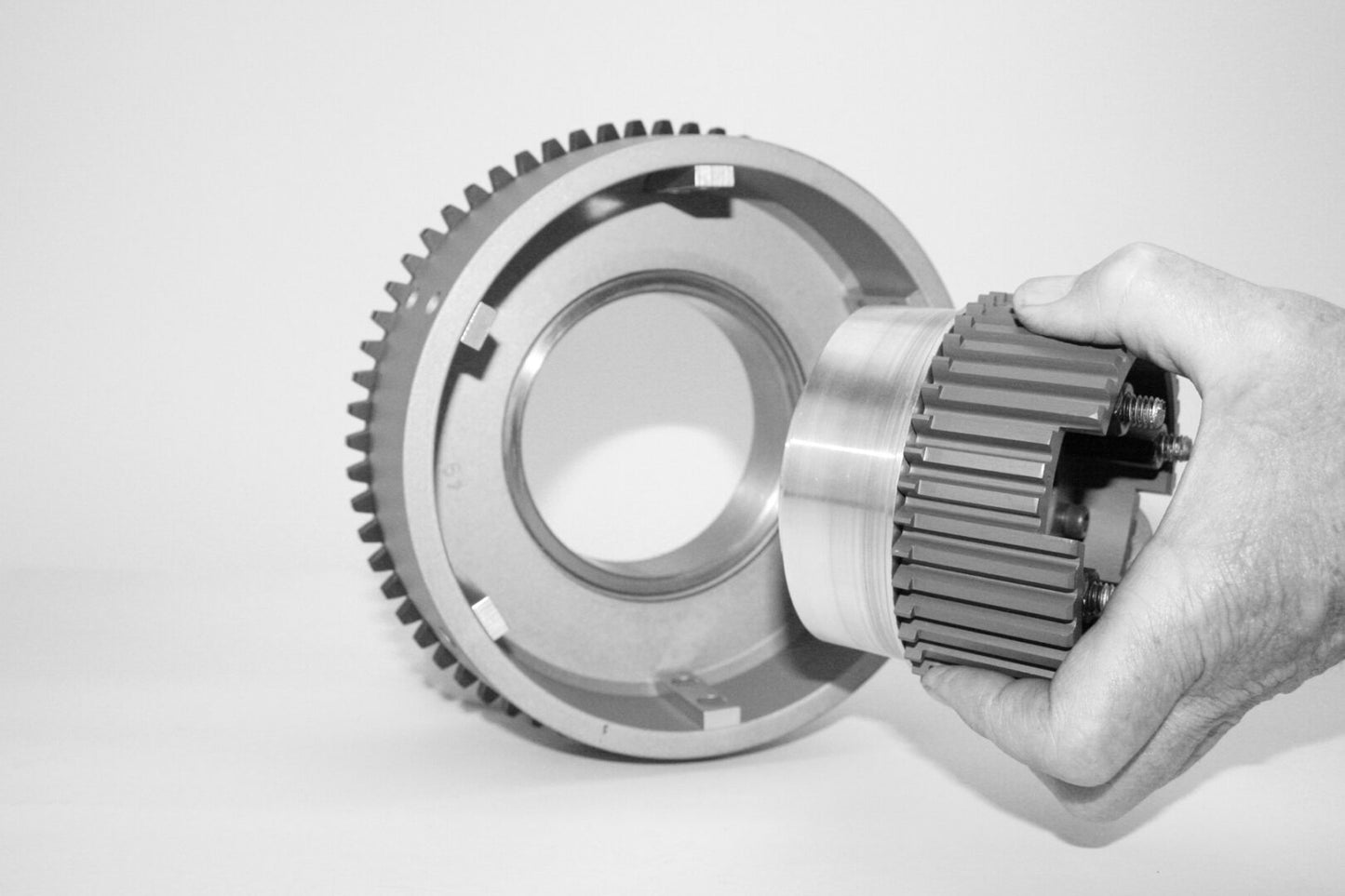 A person holding the gear of an engine